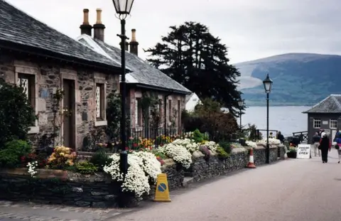 Luss village on the shore of Loch Lomond with cottages and hills